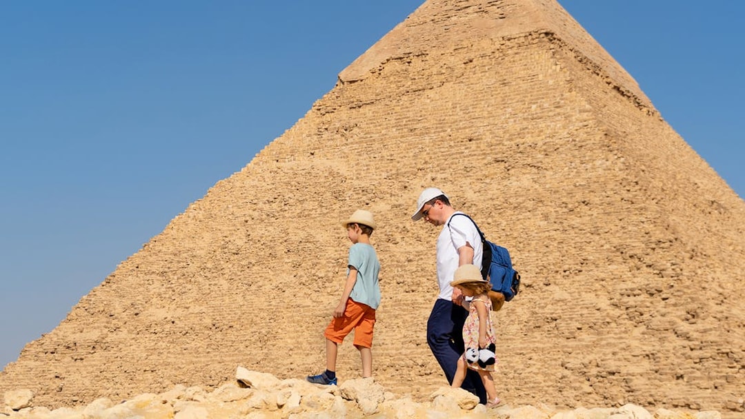 Family walking near the Pyramid of Giza, Egypt.