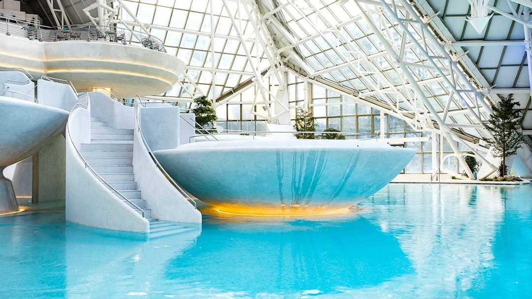 Indoor thermal pool at Caldea spa center in Andorra with modern architecture.