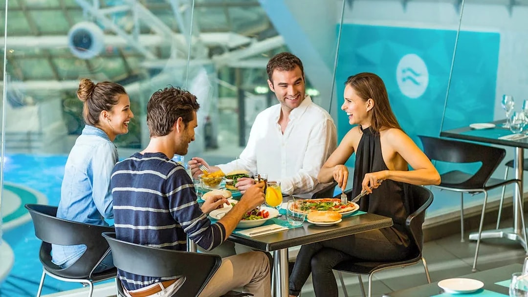 Group dining at Caldea spa restaurant, Andorra, enjoying meals by the pool.