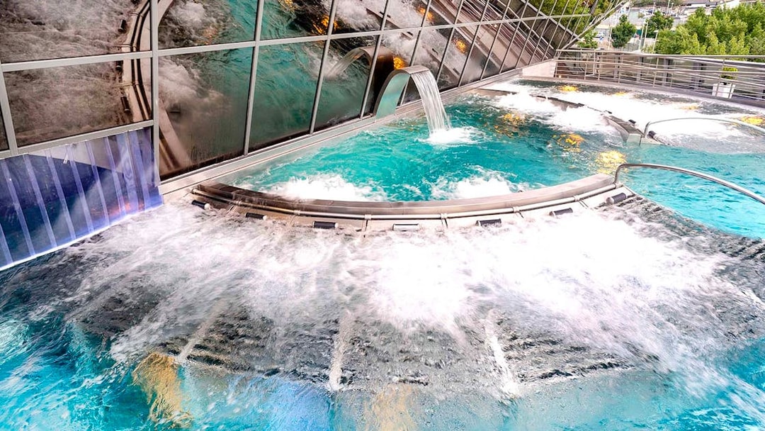 Inúu spa pool with cascading water feature at Caldea, Andorra.