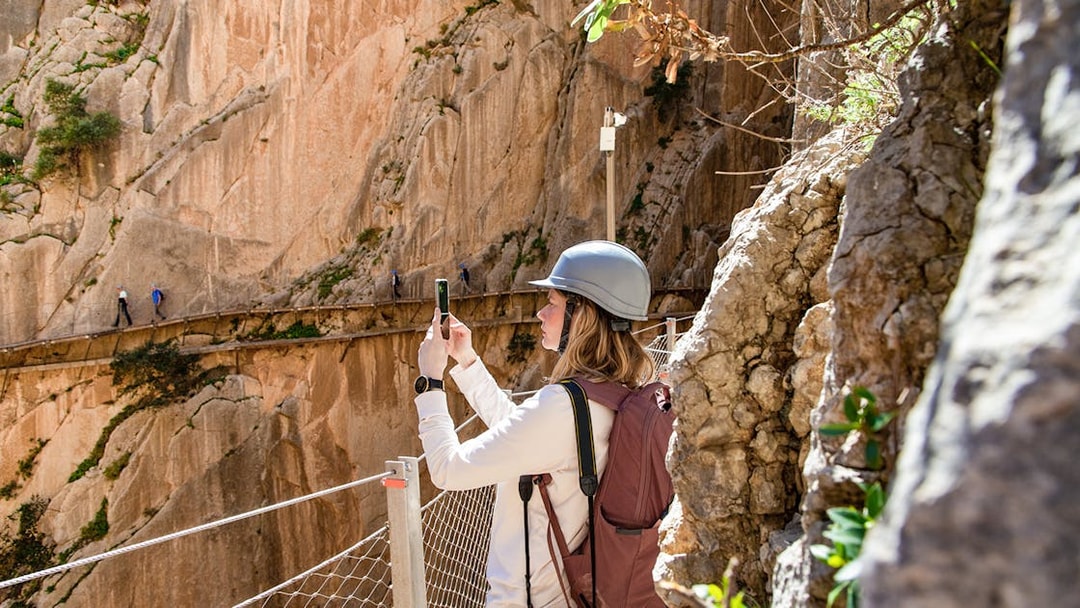 Hiker taking a photo on the Caminito del Rey trail in Malaga.