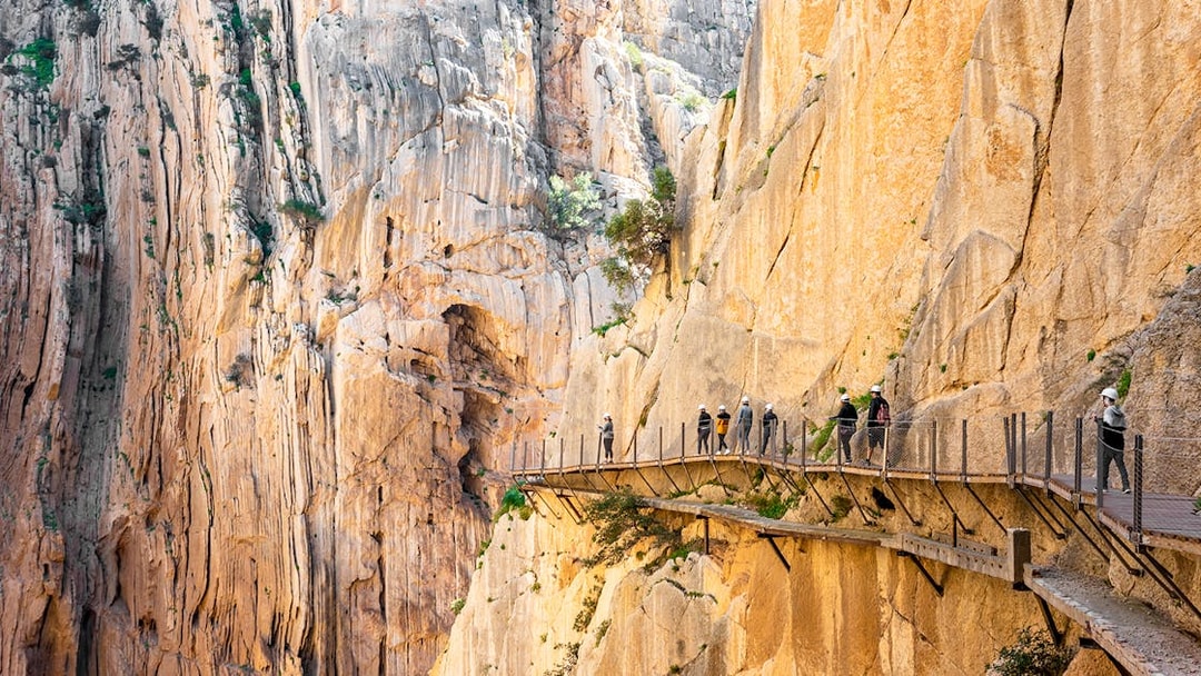 Visitors walking along the Caminito del Rey pathway in Málaga, Spain.