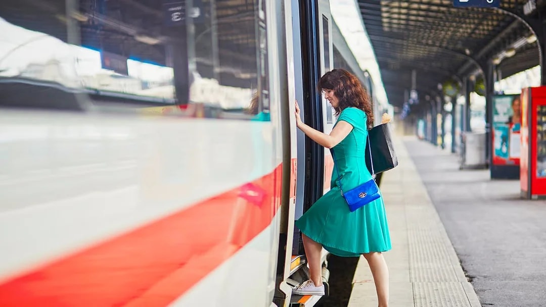 Passenger boarding train at Naples Porta Nolana station for Herculaneum transfer.