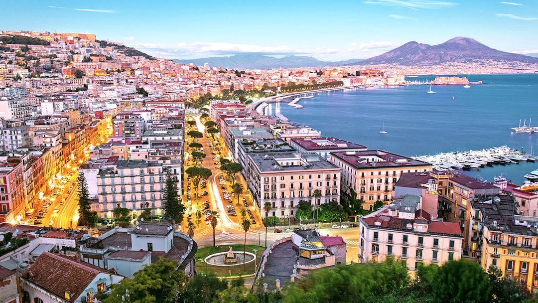 Naples cityscape with Mount Vesuvius and harbor, view from Porta Nolana area.