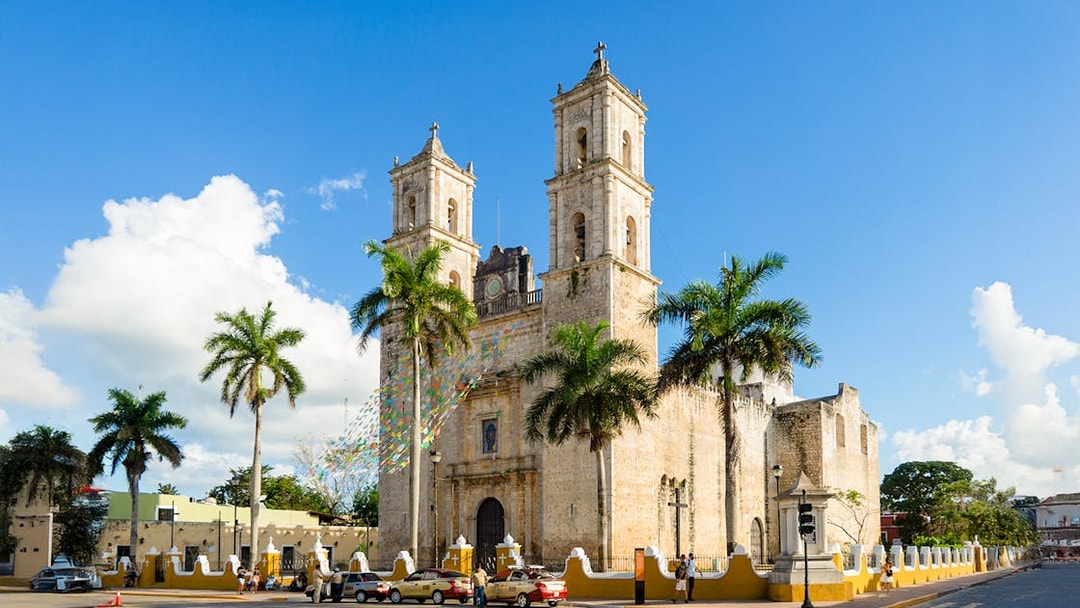 Spanish Cathedral Iglesia de San Servacio with palm trees in Valladolid, Mexico.