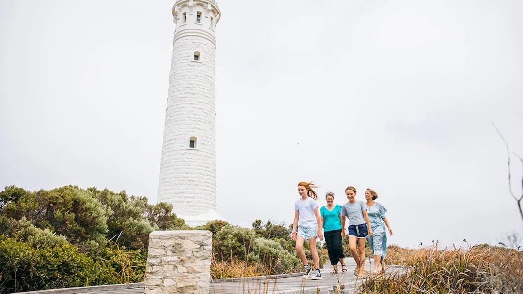 Family walking on boardwalk near Cape Leeuwin Lighthouse, Australia.