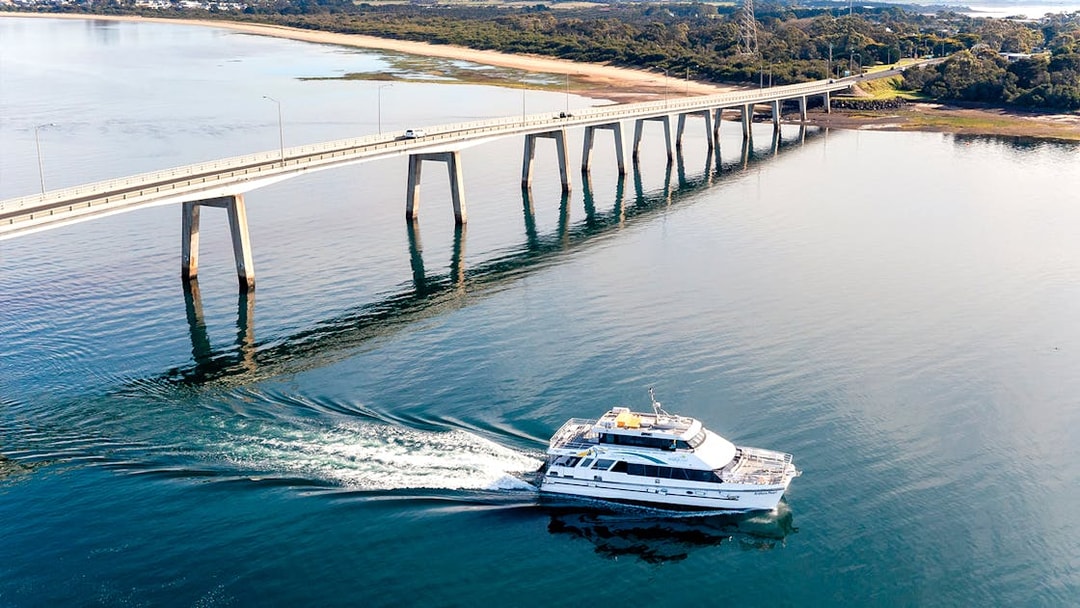 Cruise boat near bridge on Cape Woolamai coastline, Phillip Island.