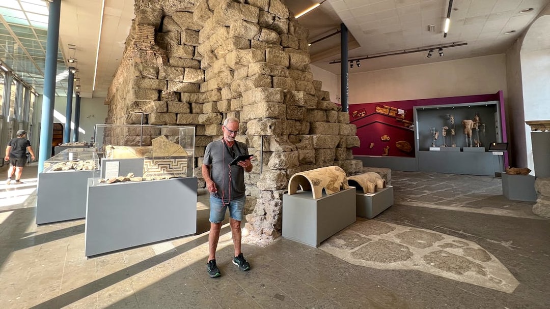 Man viewing ancient artifacts at Musei Capitolini, Rome.
