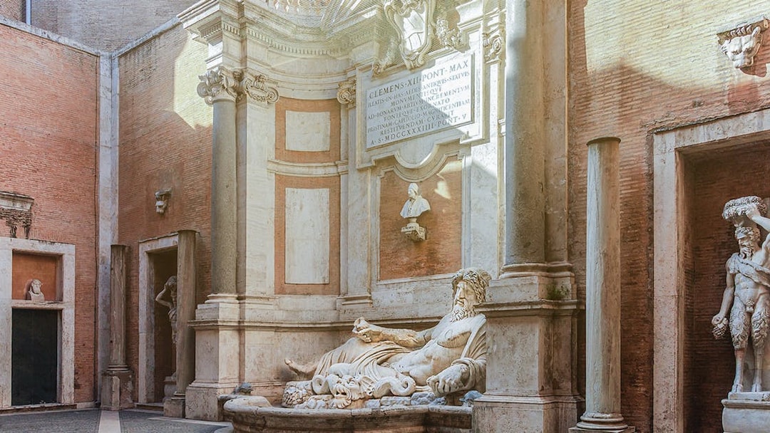 River god statue in Capitoline Museums courtyard, Rome.