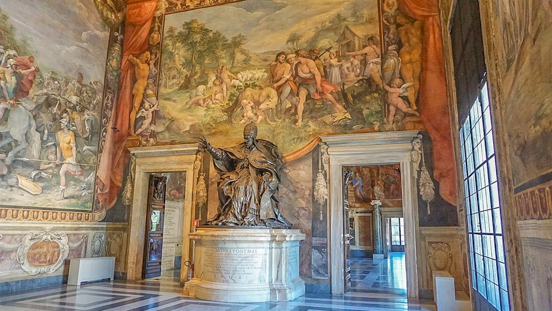Capitoline Museums interior with statue and frescoes during guided tour in Rome.