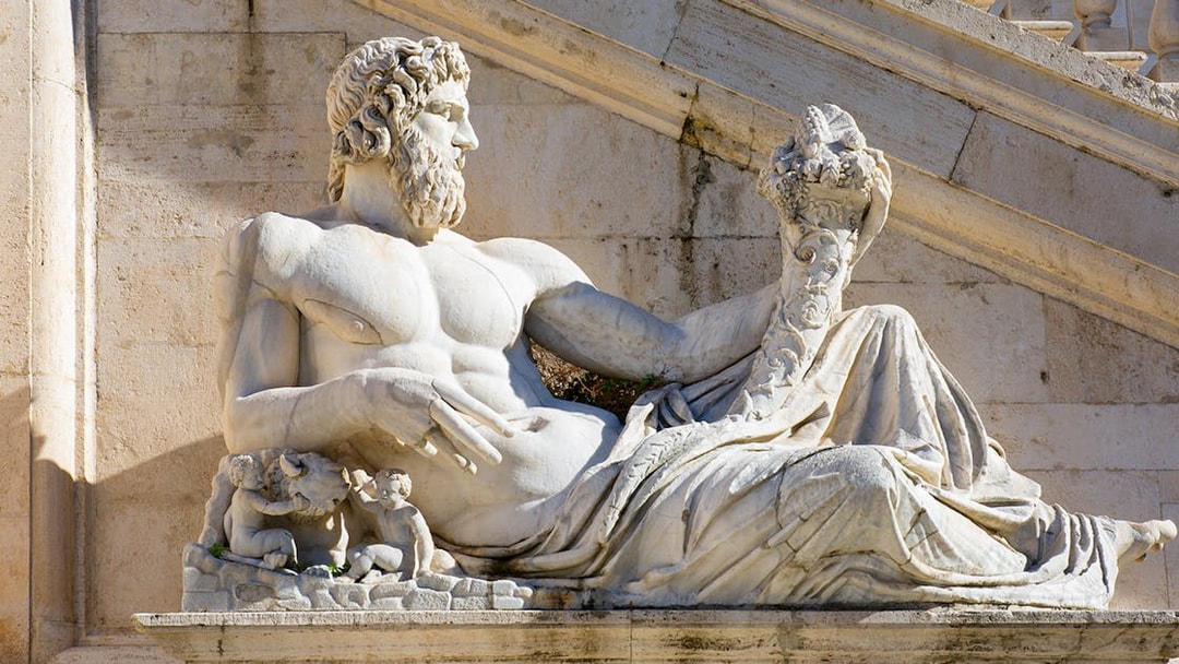 Statue of Tiber River God at Capitoline Museums, Rome, featuring reclining figure with cornucopia.