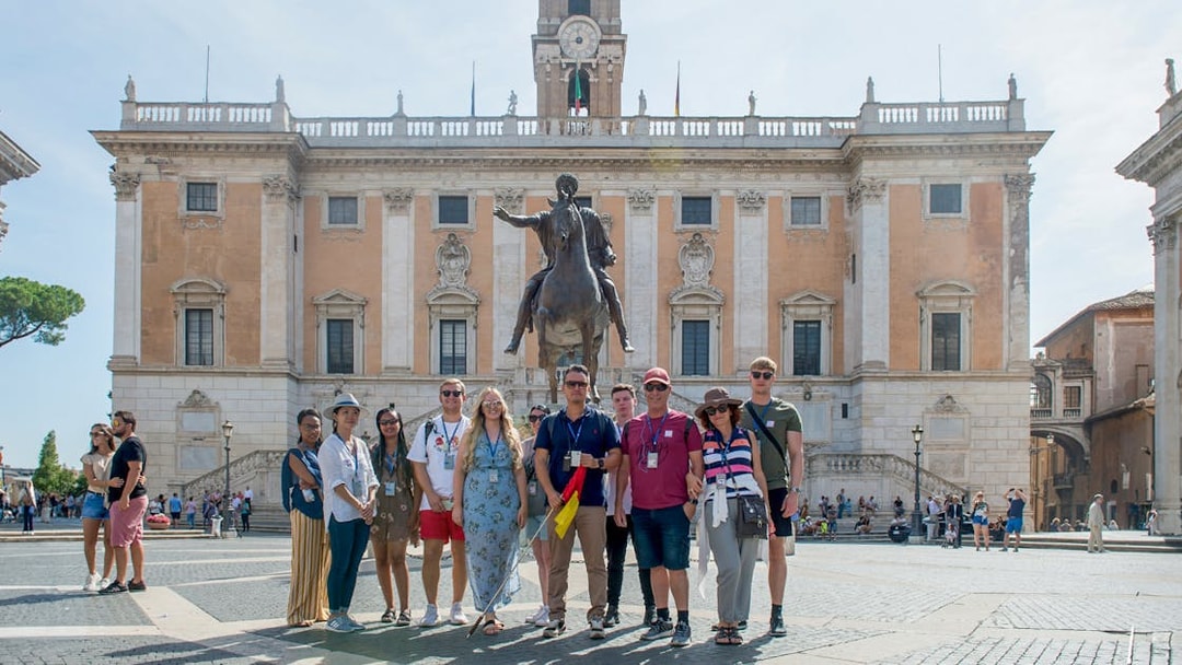 Group in front of Capitoline Museums with equestrian statue, Rome tour.