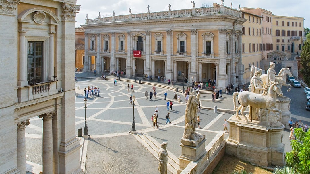 Capitoline Museums and statues in Campidoglio Square, Rome, with visitors exploring.