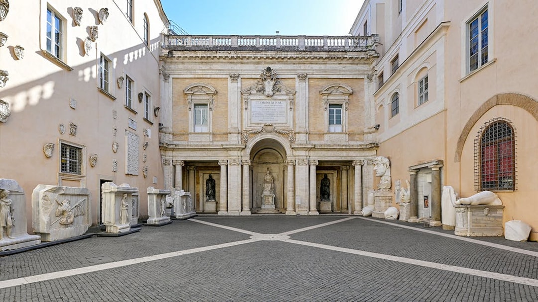 Capitoline Museums courtyard with ancient sculptures and architectural details in Rome, Italy.