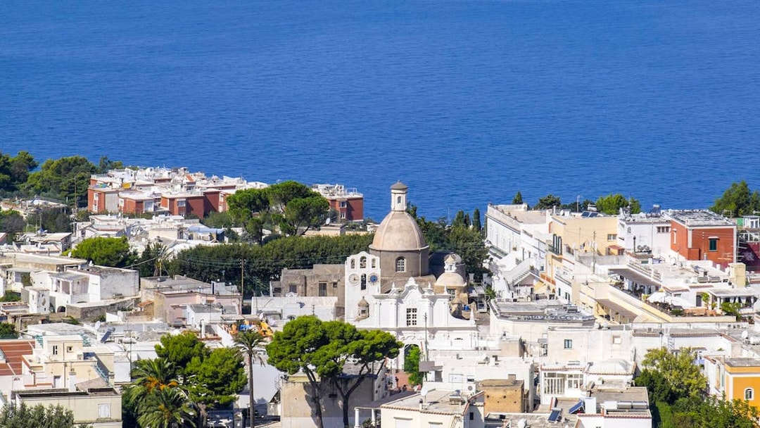 Capri Island townscape with church dome and sea view, part of guided tour with Sorrento transfers.