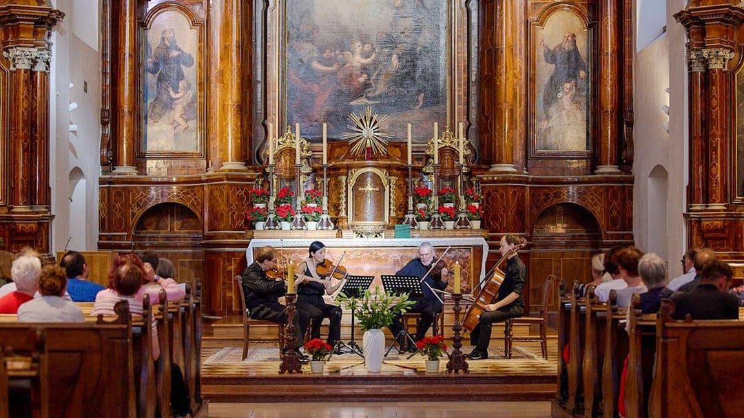 Musicians performing a classical concert inside Minoritenkirche, Vienna.