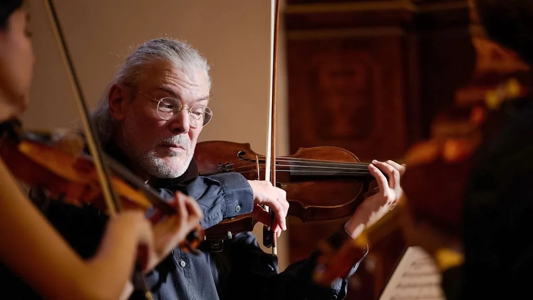 Violinist performing at Minoritenkirche classical concert in Vienna.