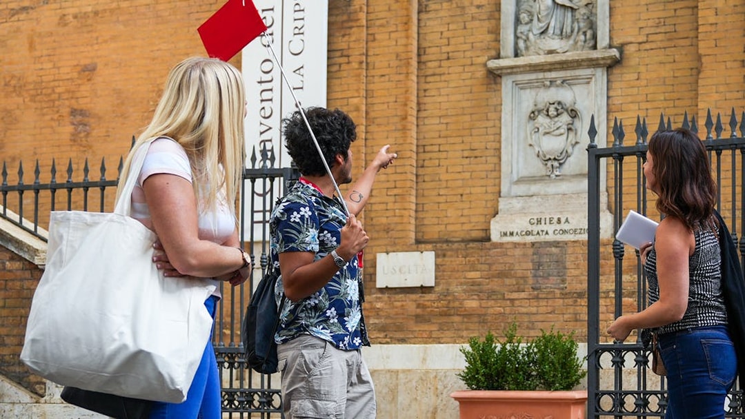 Tour guide with tourists at Santa Maria della Concezione dei Cappuccini, Rome.