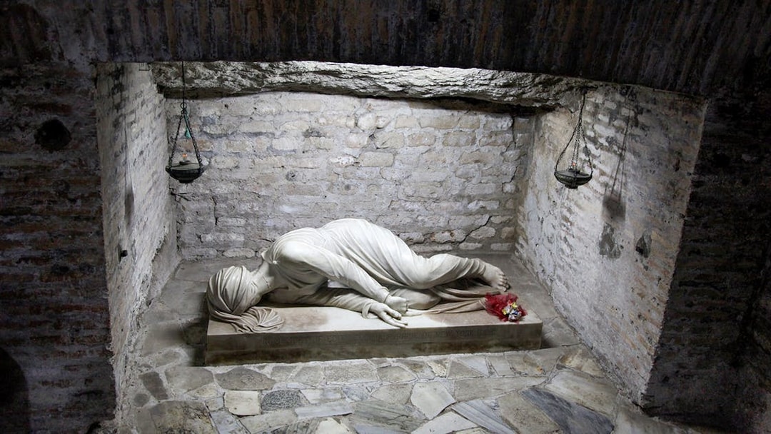 Statue in Rome crypt, part of the Crypts and Catacombs Tour with Capuchin Bone Chapel visit.