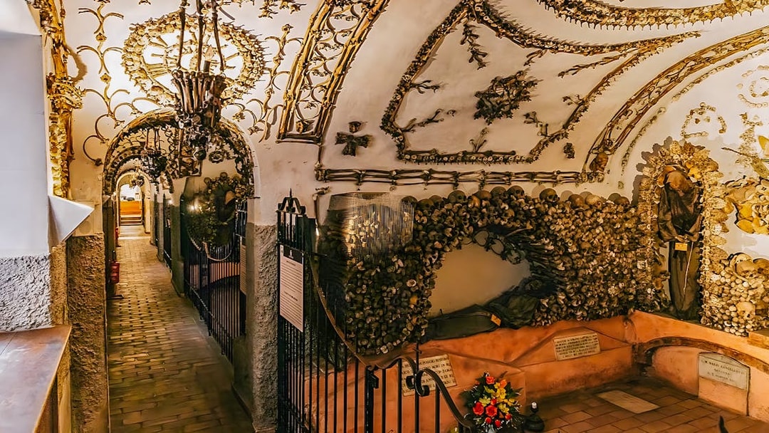 Capuchin Crypts corridor adorned with bones and religious artifacts, part of the Roman Catacombs tour.