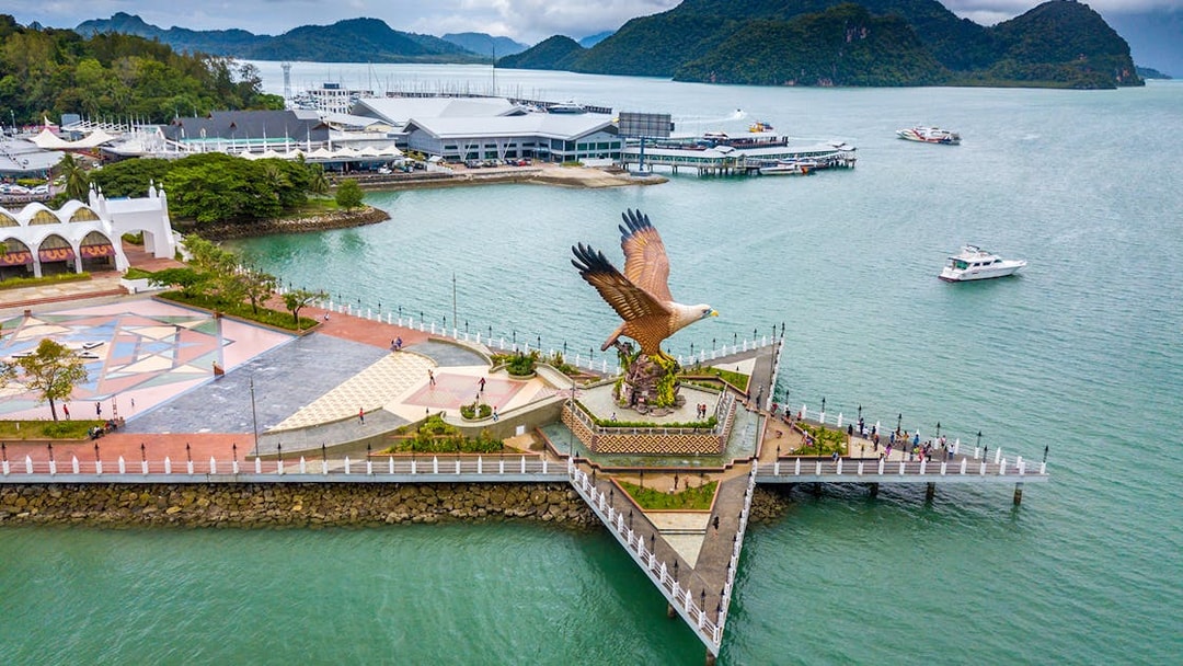 Eagle Square in Langkawi with boats and mountains in the background.