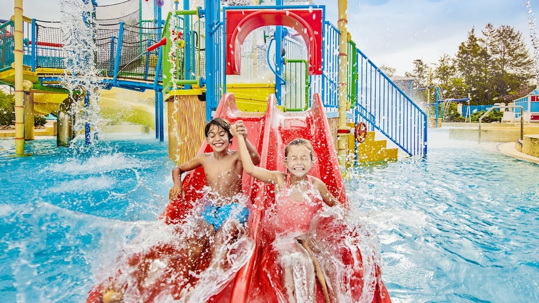 Children on a red water slide at Caribe Aquatic Park.