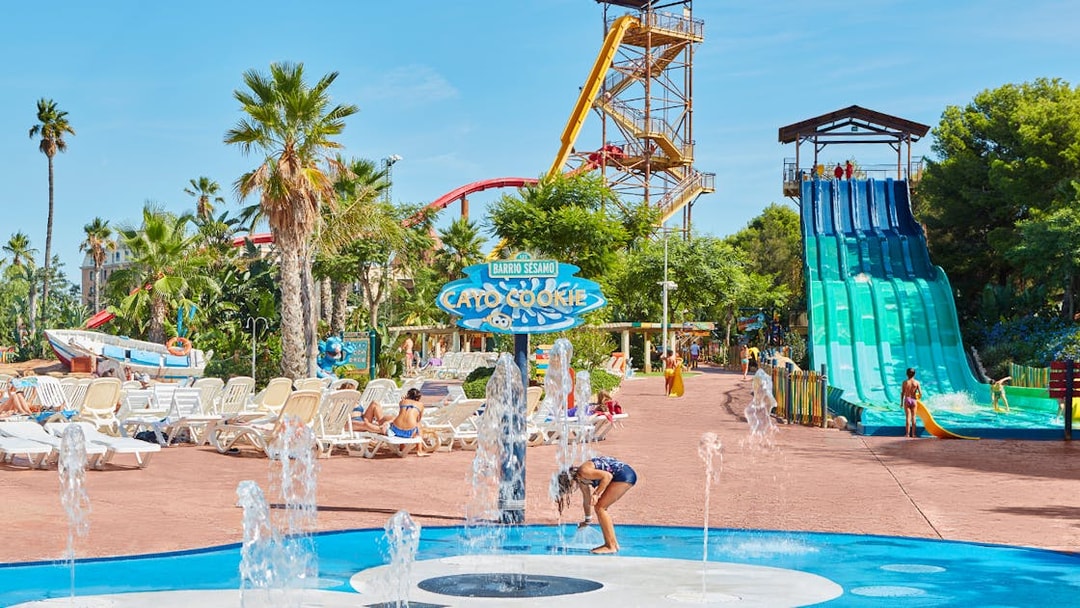 Children playing in splash area with water slides at Costa Caribe Aquatic Park.