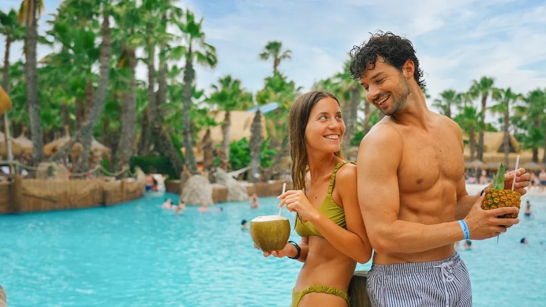 Friends enjoying drinks by the pool at Caribe Bay.