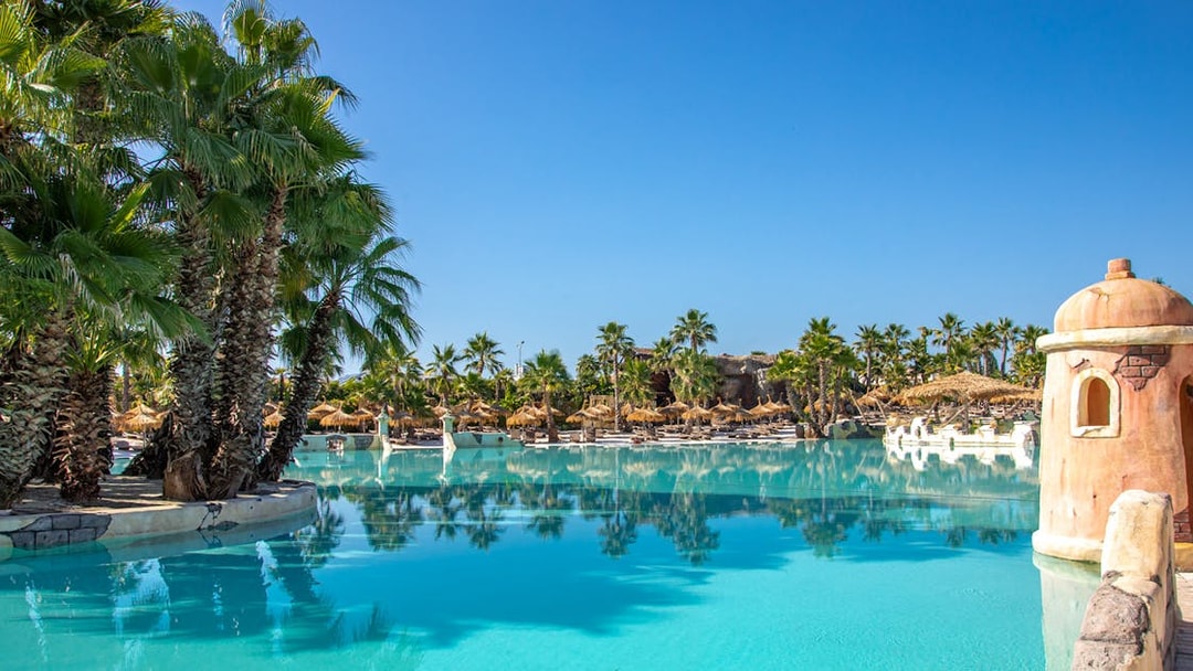 Caribe Bay water park with palm trees and lagoon, Italy.