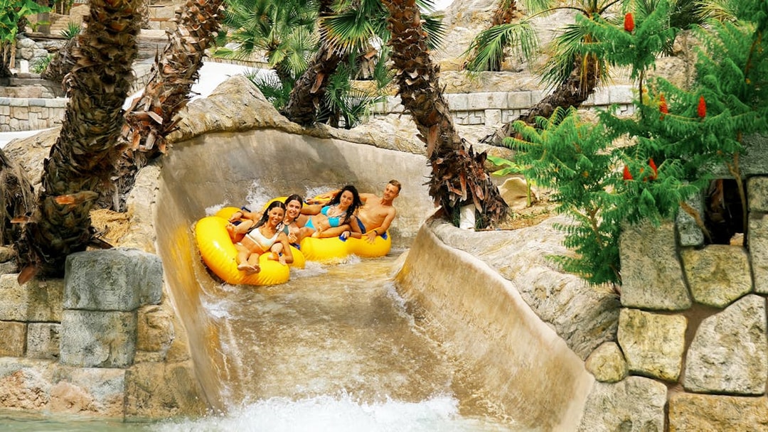 Tourists on yellow tubes enjoying a water slide at Caribe Bay.