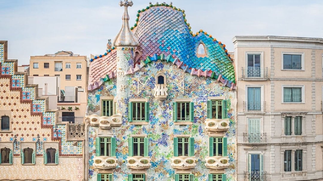 Casa Batlló facade with colorful mosaic tiles in Barcelona.