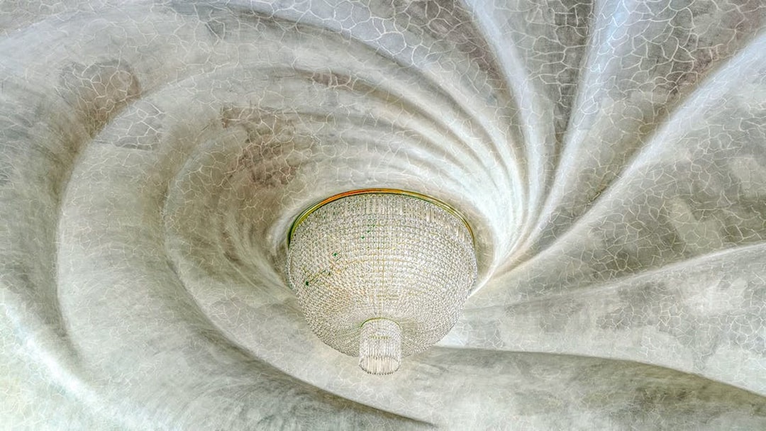 Casa Batlló ceiling with ornate chandelier, Barcelona.