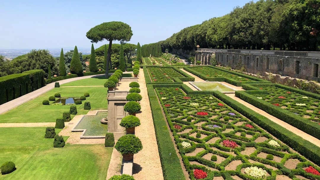Castle Gandolfo garden with manicured hedges, fountains, and scenic pathways.