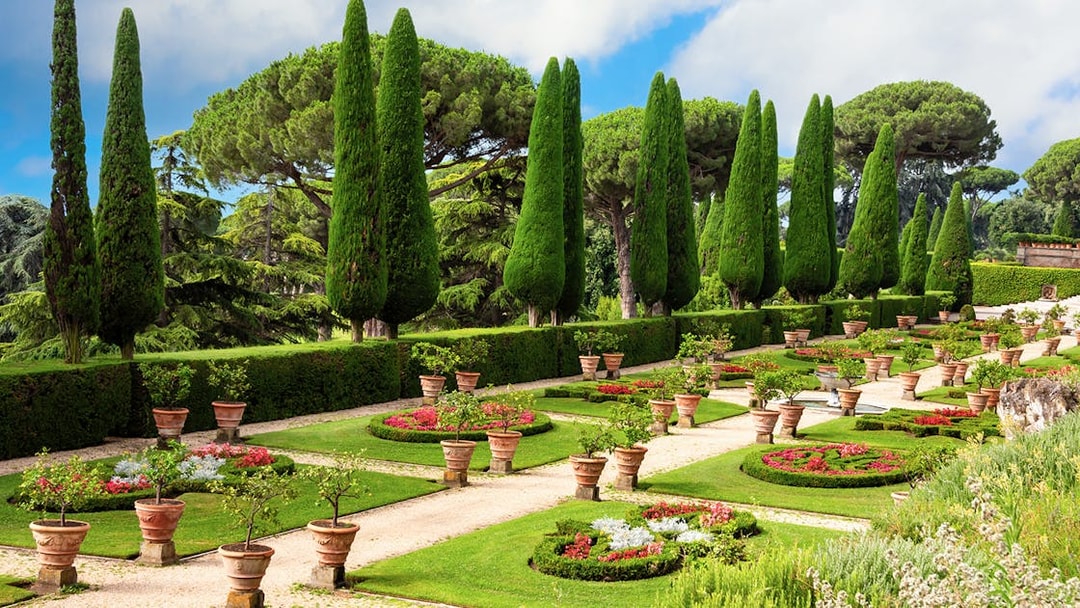 Pontifical Villa Gardens at Castel Gandolfo with manicured paths and cypress trees.
