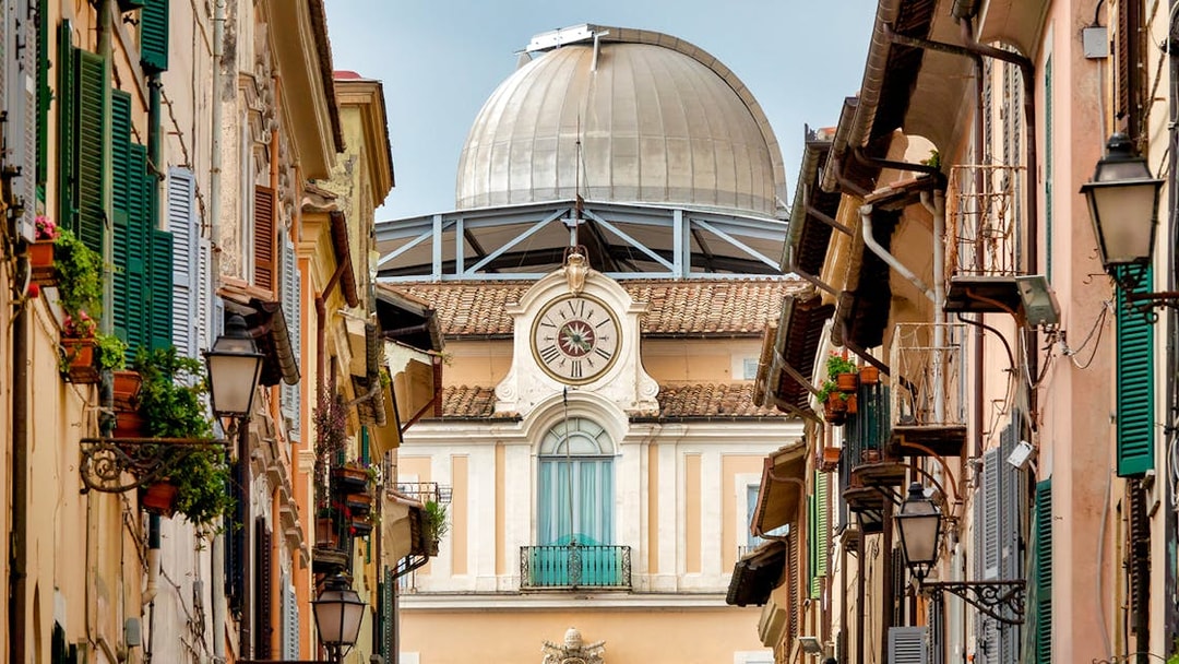 Vatican Observatory dome viewed from a narrow street in Castel Gandolfo, Italy.