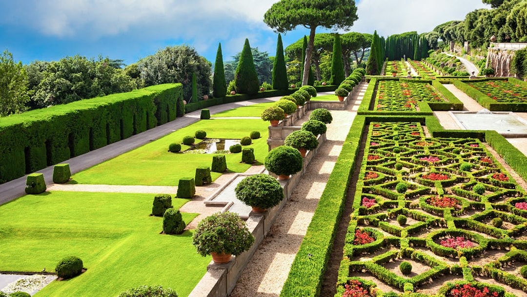 Terraced gardens with hedges and flower beds in Castel Gandolfo park, Italy.