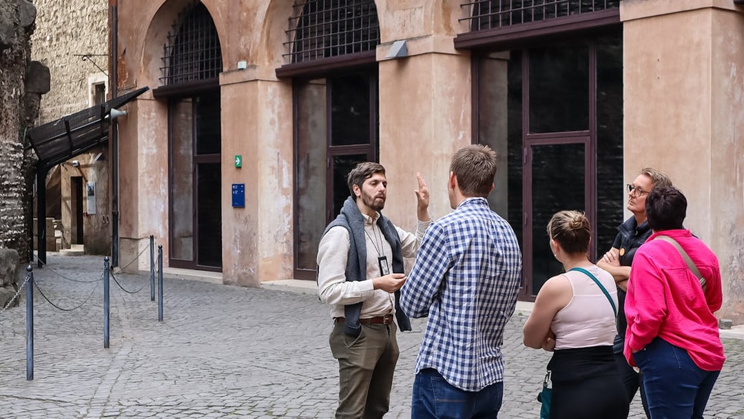 Tour guide explaining history to a group at Castel Sant'Angelo, Rome.