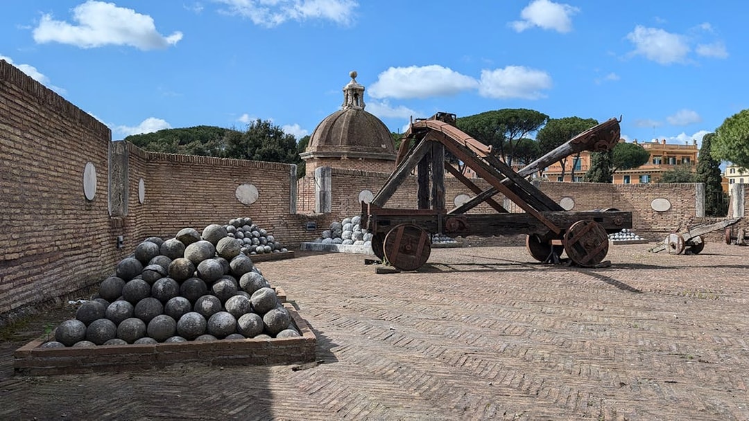 Cannons and catapult at Castel Sant'Angelo, Rome, with stone cannonballs.