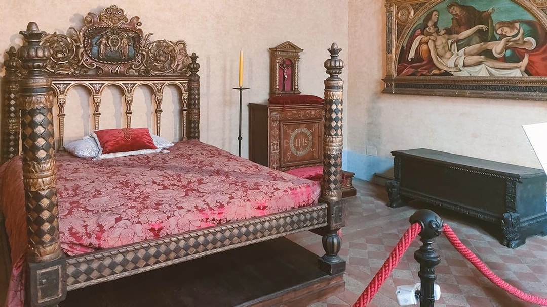 Ornate bedroom with carved bed in Castel Sant'Angelo, Rome.