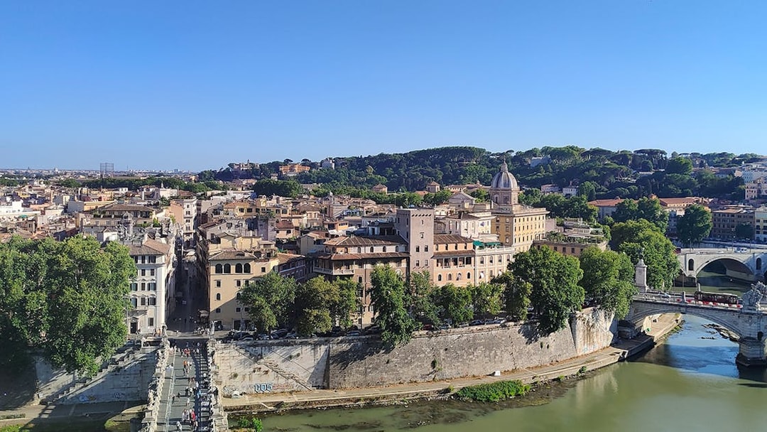 View of Rome from Castel Sant'Angelo, featuring the Tiber River and historic buildings.