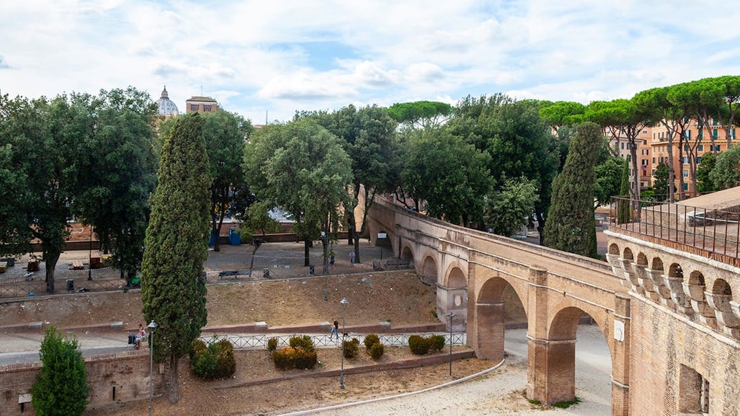 Passetto di Borgo walkway in Rome with trees and historic arches.