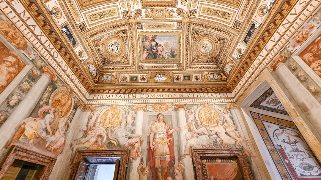 Interior of Castel Sant'Angelo featuring ornate ceiling details and frescoes in Rome, Italy.