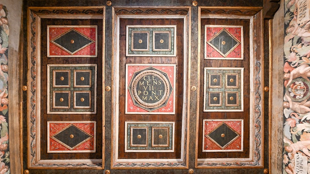 Ceiling details of Castel Sant'Angelo interior featuring ornate geometric patterns and inscriptions.