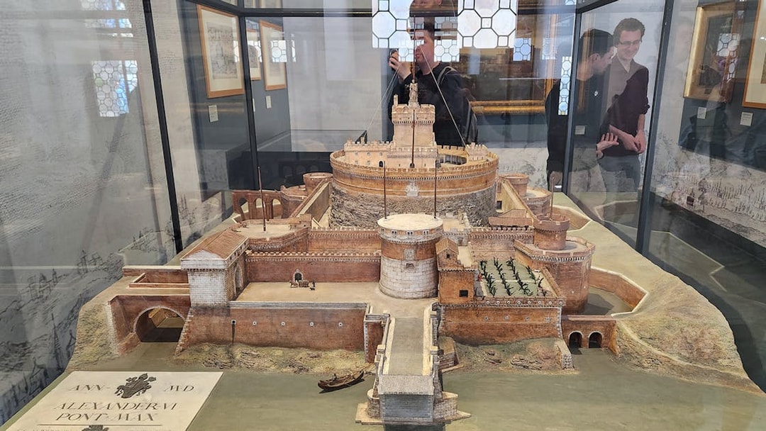 Miniature model of Castel Sant'Angelo in Rome, showcasing detailed architecture and surrounding landscape.