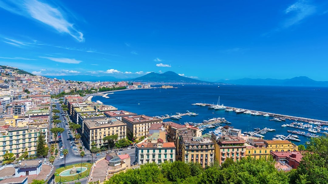 Panoramic view of Naples cityscape with Mount Vesuvius in the background.
