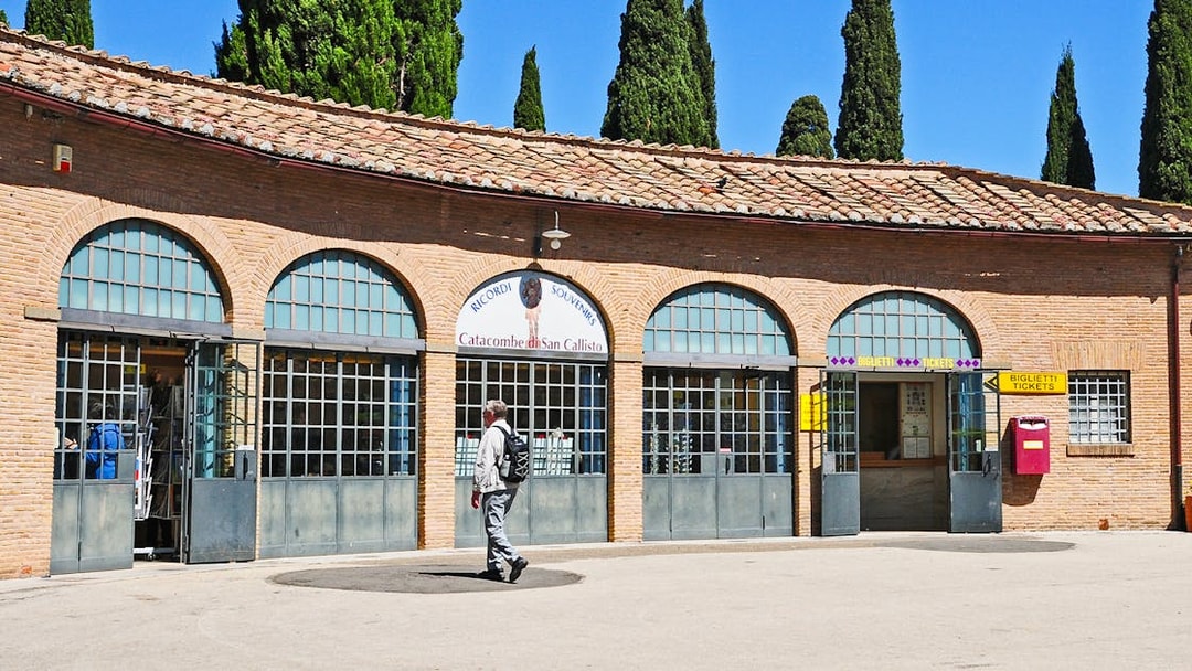 Tourist entering ticket office for Catacombs of St. Callixtus in Rome.