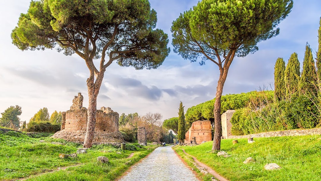 Ancient ruins and trees along the Appian Way in Rome.