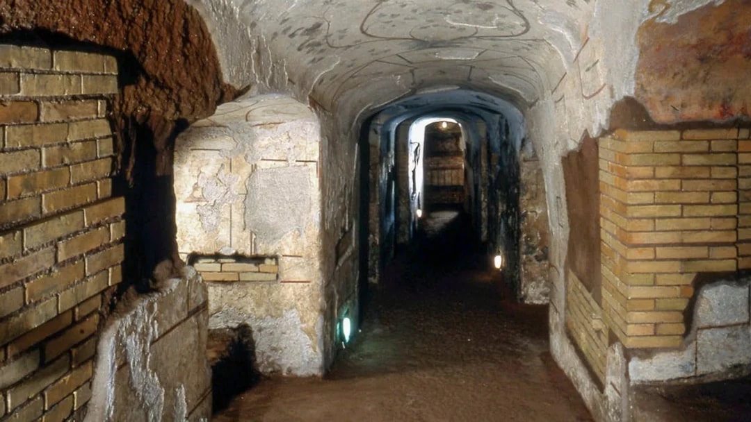 Catacombs of Domitilla corridor with ancient brick walls, Rome.