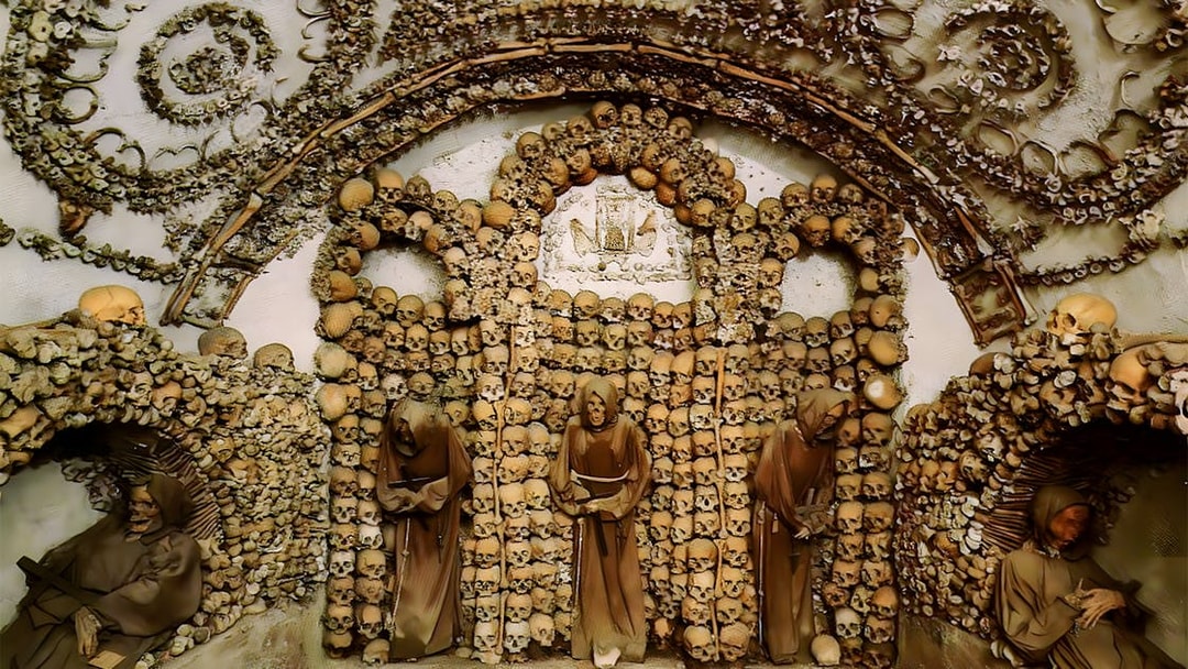 Capuchin Crypt in Rome Catacombs with monk statues and skull decorations.