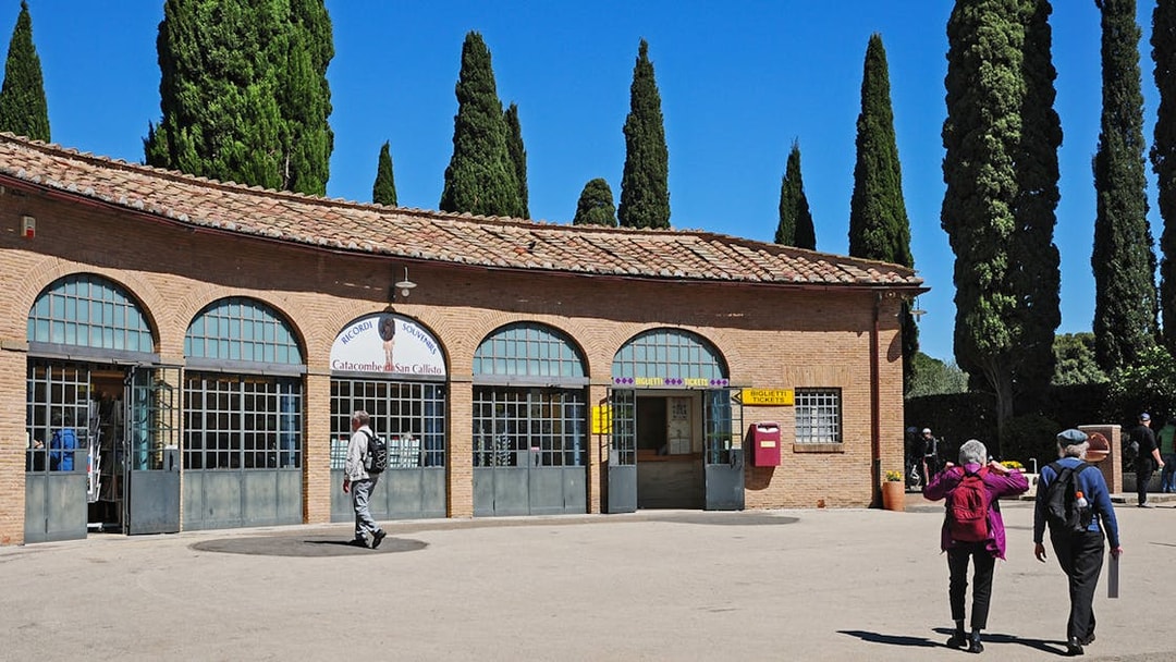 Entrance to Catacombs of St Callixtus with visitors approaching ticket office, Rome.